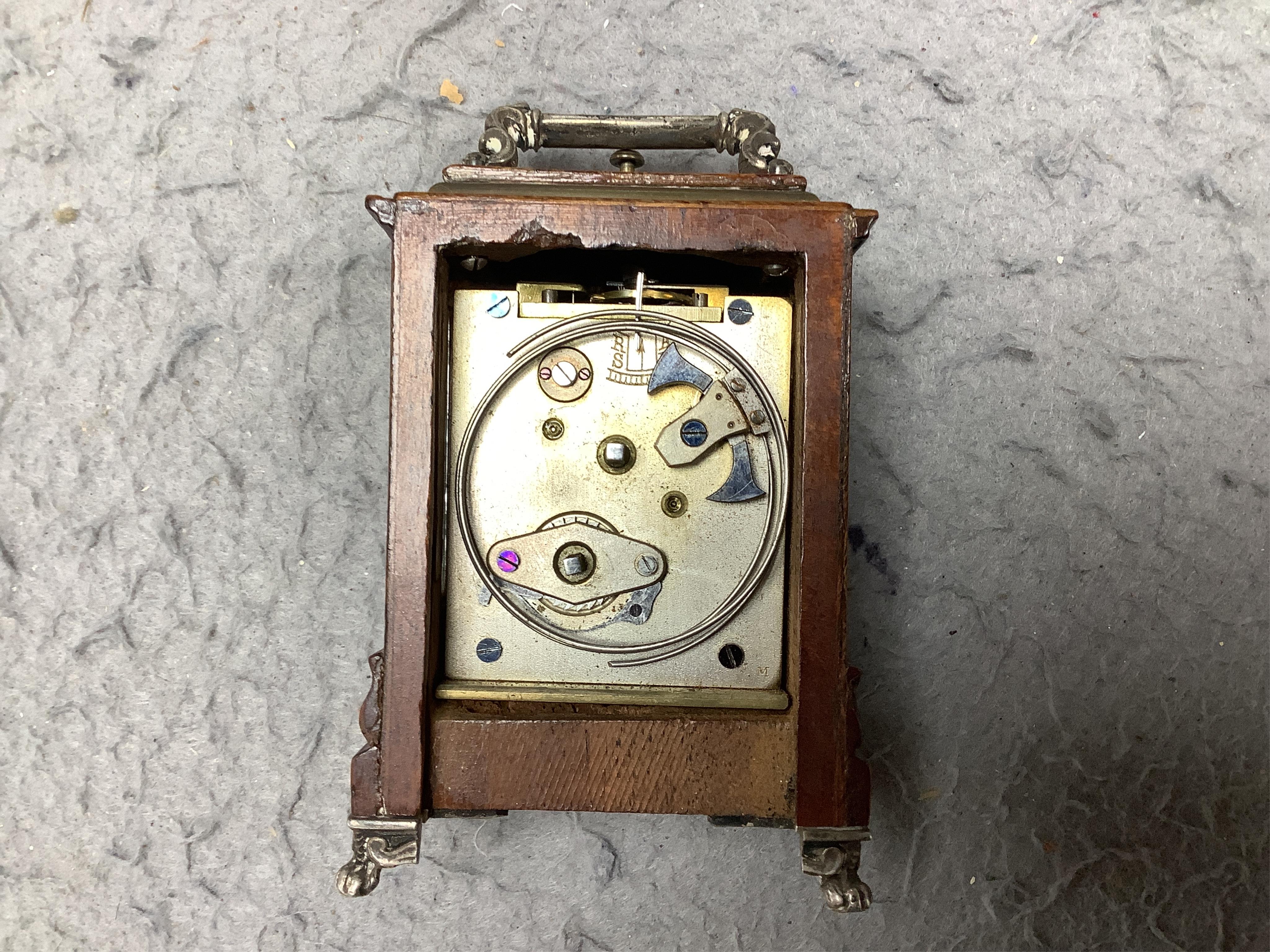 An early 20th century walnut miniature repeating carriage clock, with key, 8.5cm. Condition - fair, currently ticking